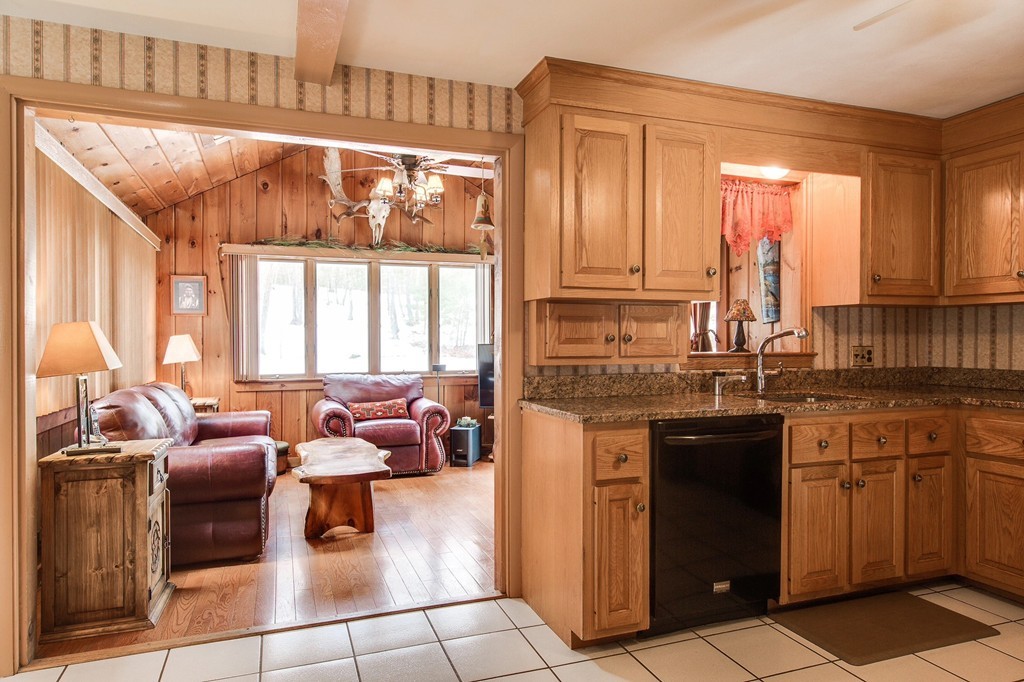 153 Leslie Road Rowley, MA 01969 - Photo 3 of 21 a kitchen with granite countertop a sink and a refrigerator