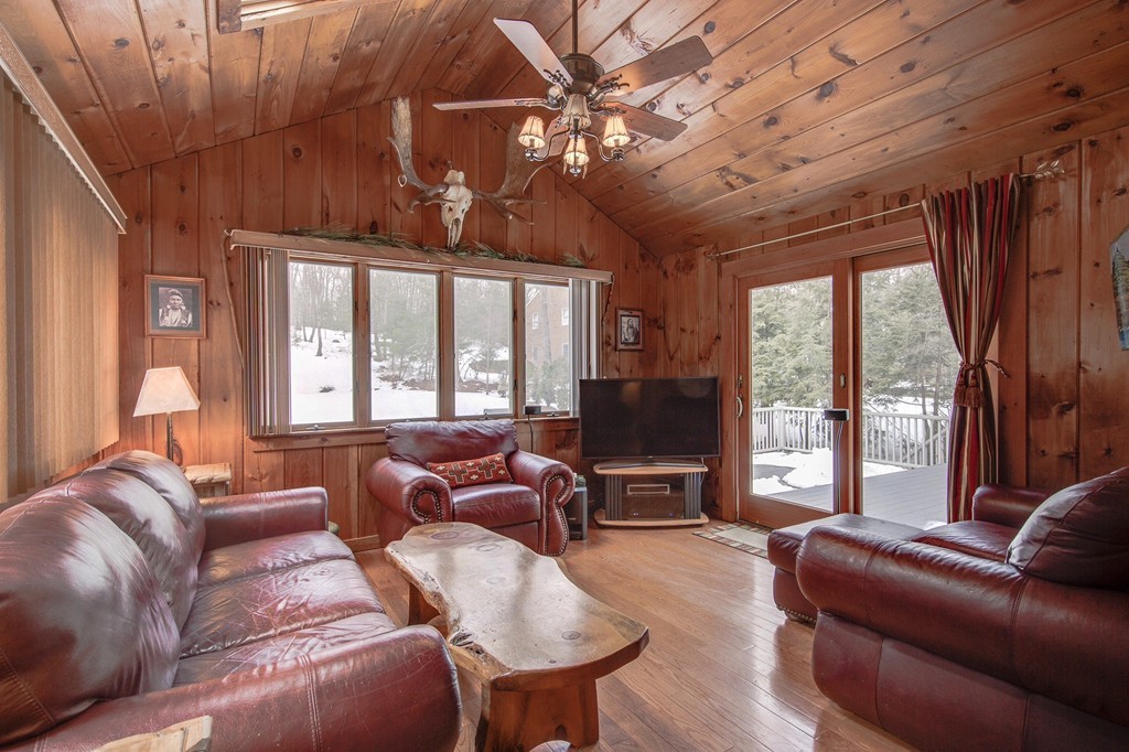 153 Leslie Road Rowley, MA 01969 - Photo 8 of 21 a living room with furniture a ceiling fan and a large window