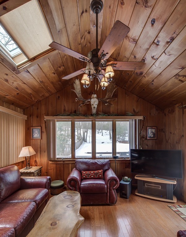 153 Leslie Road Rowley, MA 01969 - Photo 9 of 21 a living room with furniture a chandelier and a large window