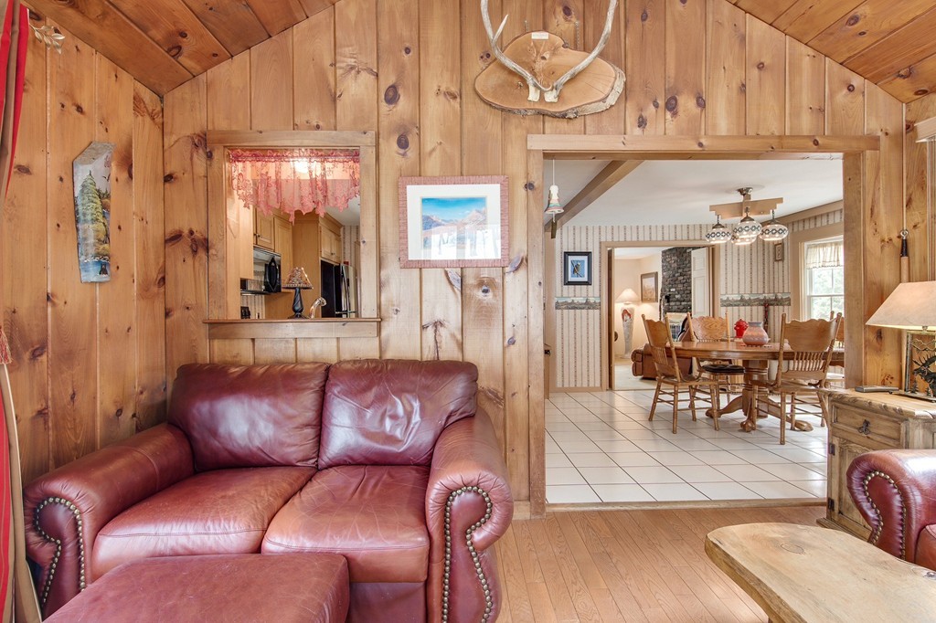 153 Leslie Road Rowley, MA 01969 - Photo 10 of 21 a living room with furniture a wooden floor and a chandelier