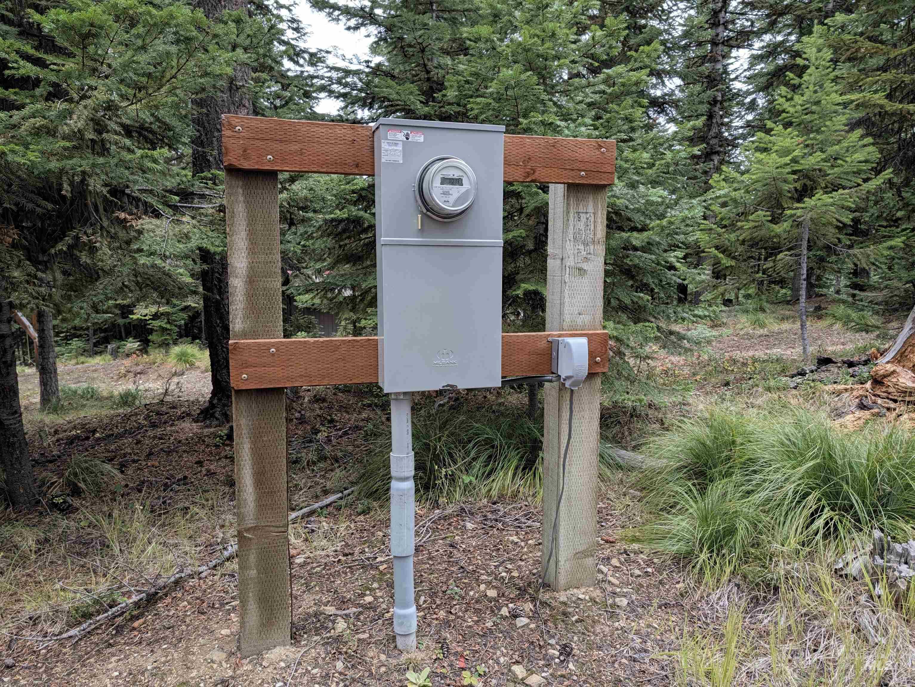 524 Rhett Creek Road Elk City, ID 83525 - Photo 5 of 23 Utility box with meter, mounted on wooden posts, surrounded by natural ground cover