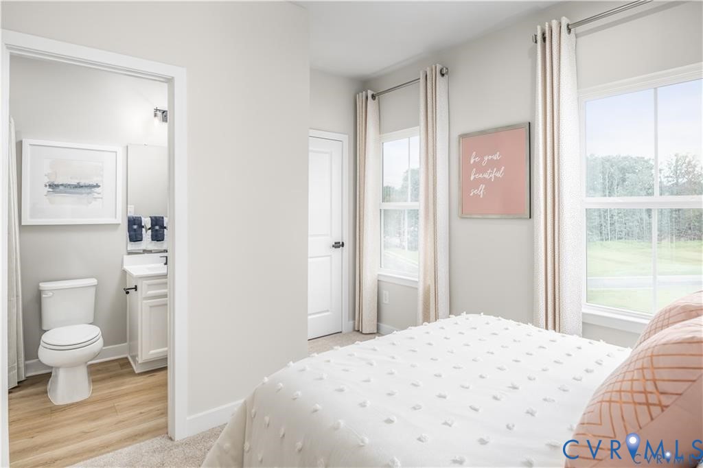 4719 Cloverleigh Drive Midlothian, VA 23112 - Photo 19 of 24 a bedroom with a bed and a potted plant