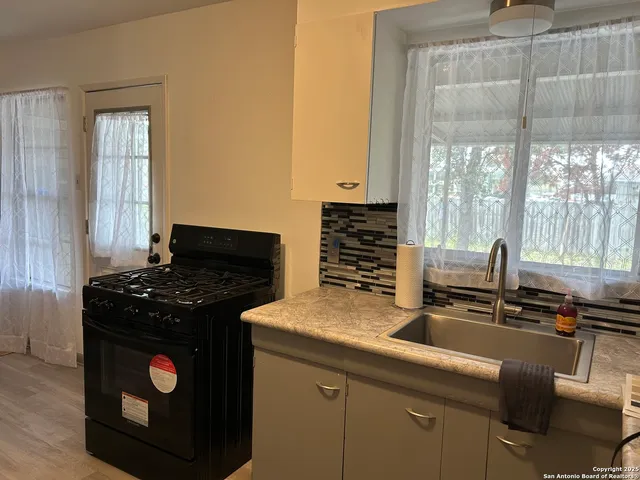 a kitchen with a stove and a sink