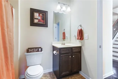 a bathroom with a toilet a sink and a mirror