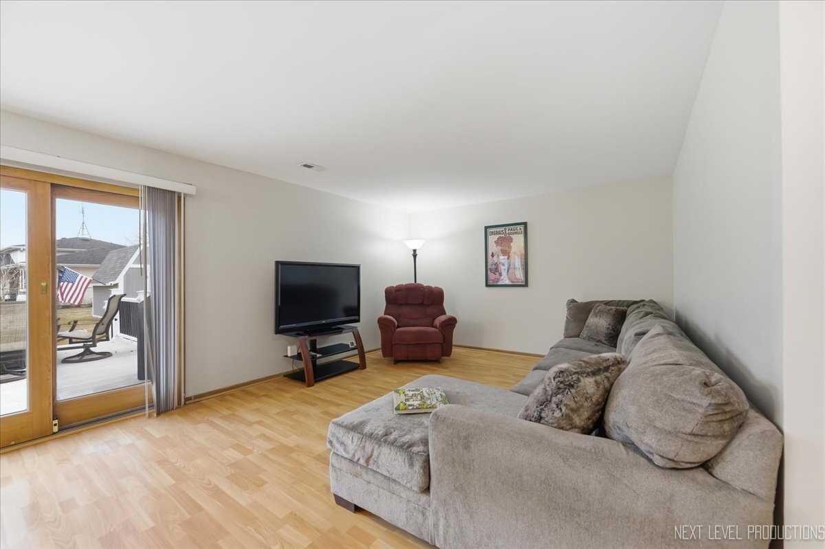 104 Augusta Road Oswego, IL 60543 - Photo 11 of 24 a living room with furniture and a flat screen tv