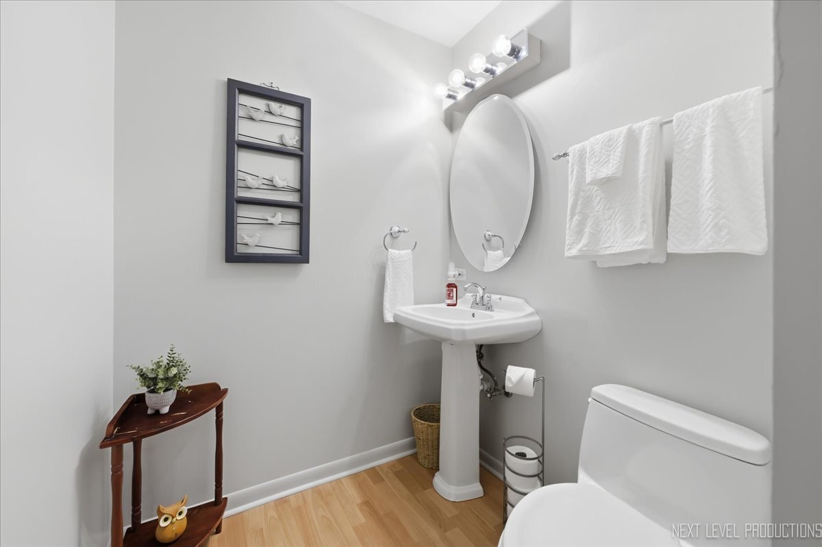 104 Augusta Road Oswego, IL 60543 - Photo 12 of 24 a bathroom with a toilet sink and mirror