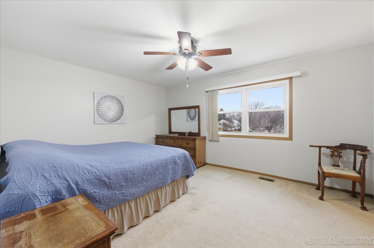 104 Augusta Road Oswego, IL 60543 - Photo 13 of 24 a bedroom with a bed and window