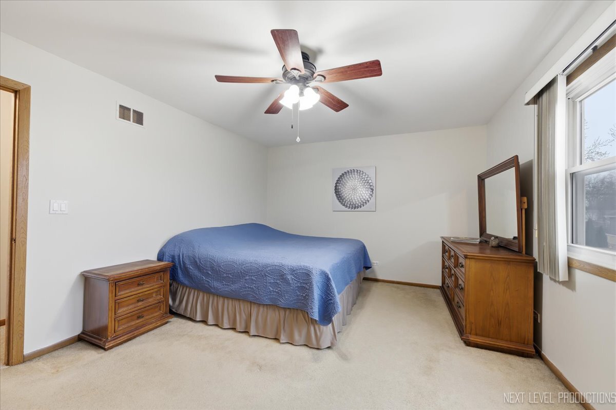 104 Augusta Road Oswego, IL 60543 - Photo 14 of 24 a bed room with a bed and a ceiling fan