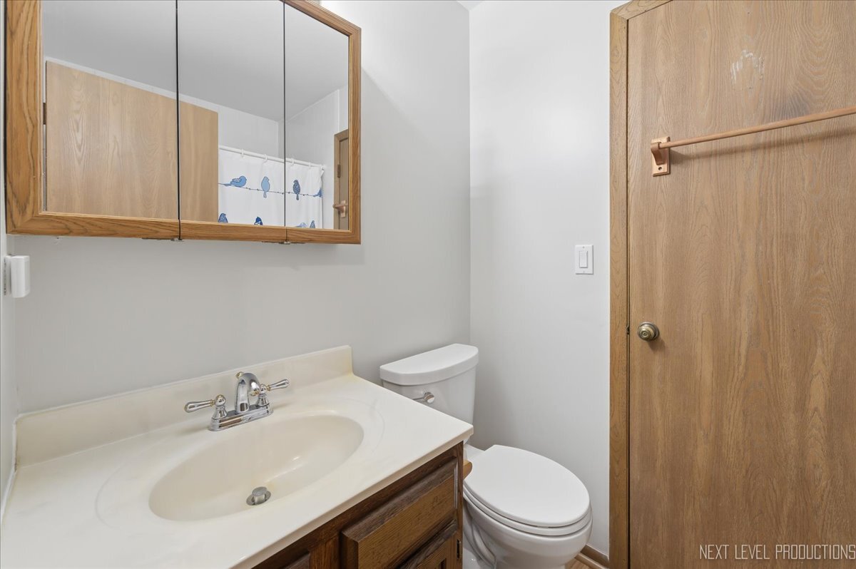 104 Augusta Road Oswego, IL 60543 - Photo 15 of 24 a bathroom with a sink a toilet and mirror