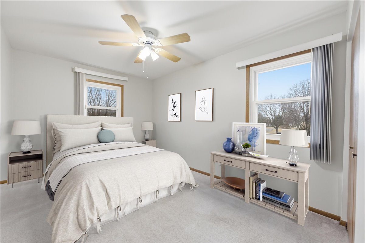 104 Augusta Road Oswego, IL 60543 - Photo 16 of 24 a bedroom with a bed and a chandelier