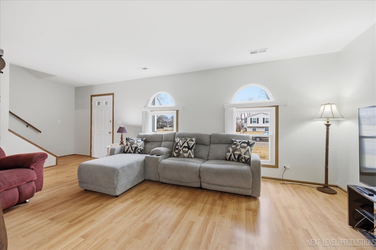 104 Augusta Road Oswego, IL 60543 - Photo 3 of 24 a living room with furniture and a flat screen tv