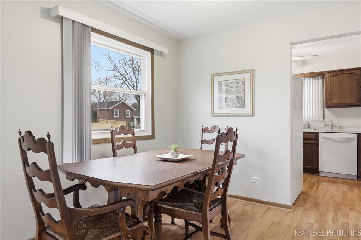 104 Augusta Road Oswego, IL 60543 - Photo 5 of 24 a view of a dining room with furniture and wooden floor