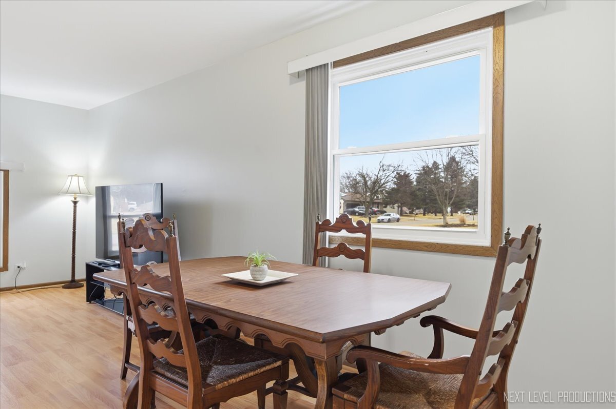 104 Augusta Road Oswego, IL 60543 - Photo 6 of 24 a view of a dining room with furniture and window