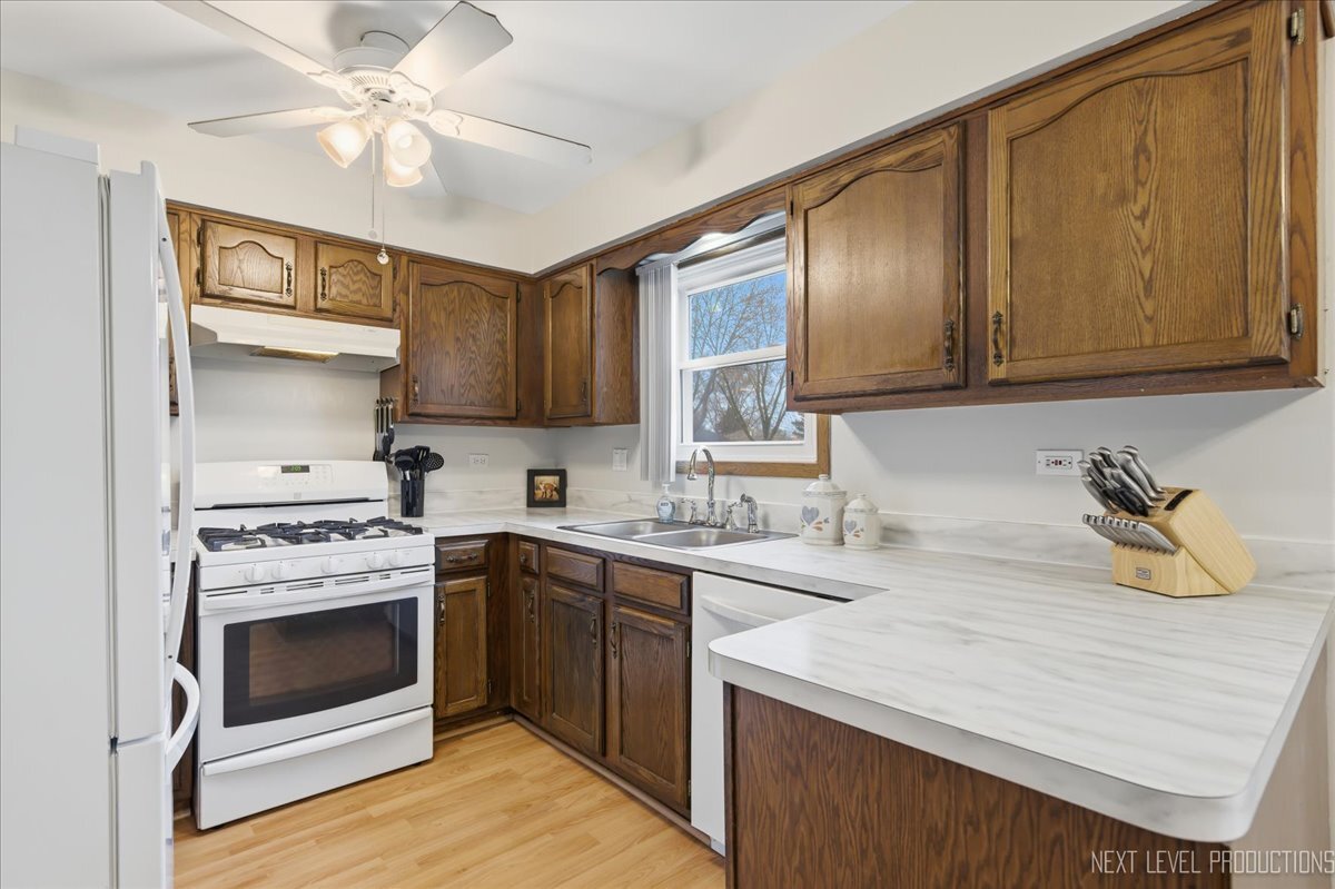 104 Augusta Road Oswego, IL 60543 - Photo 7 of 24 a kitchen with a stove oven and sink