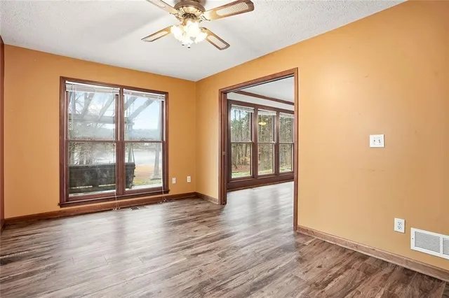 a view of room with hardwood floor and ceiling fan
