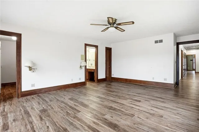 a view of a room with wooden floor and cabinet