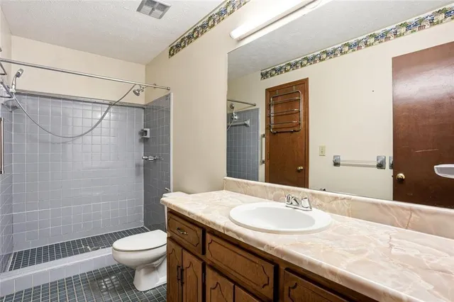 an empty room with a ceiling fan and window