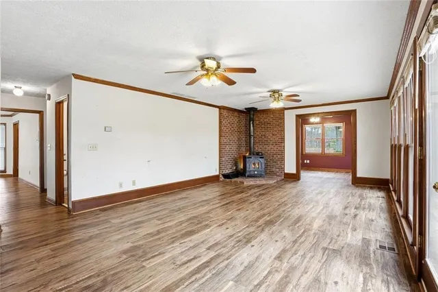 a kitchen with granite countertop wooden floors and stainless steel appliances