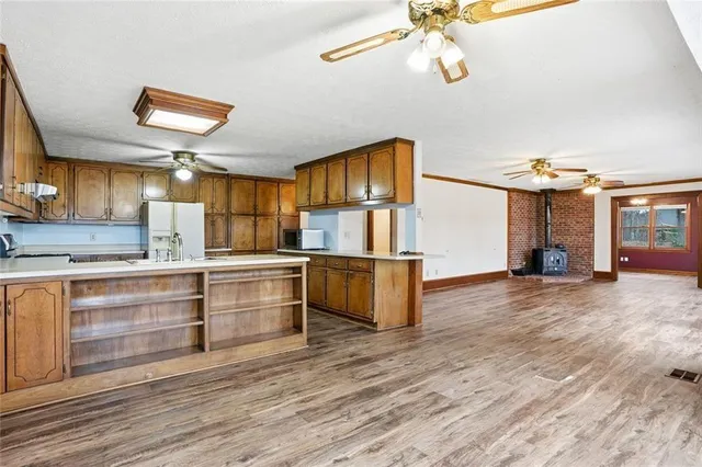a large kitchen with stainless steel appliances granite countertop a stove and a sink