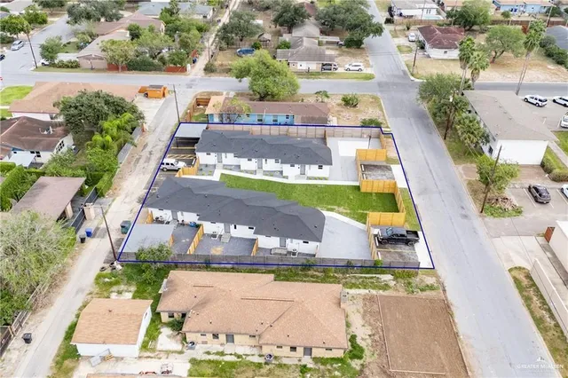 an aerial view of a swimming pool with a yard