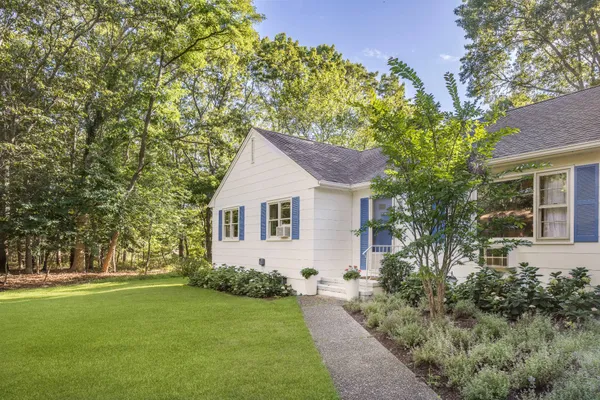 a front view of house with yard and green space