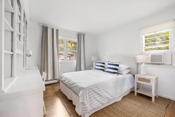 a bedroom with a bed and a window