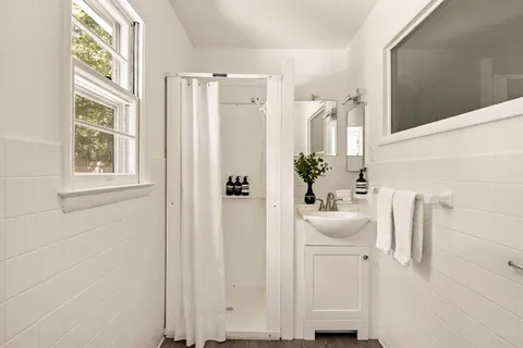 a bathroom with a sink a mirror and a window