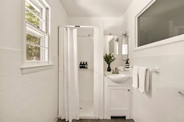 a bathroom with a sink a mirror and a window