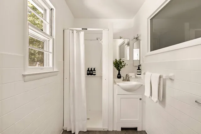 a bathroom with a sink a mirror and a window