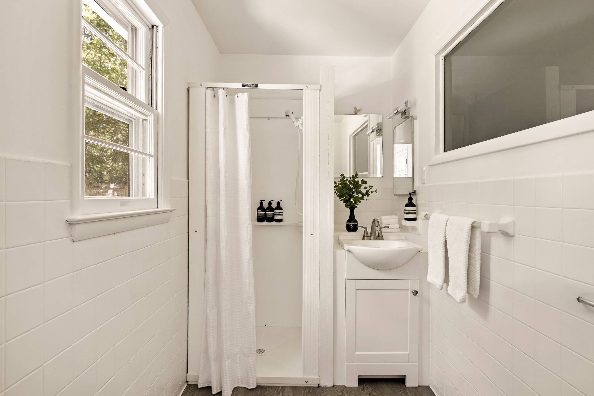1635 Sagg Road Sag Harbor, NY 11963 - Photo 14 of 19 a bathroom with a sink a mirror and a window