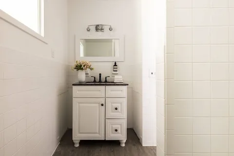 a bathroom with a double vanity sink and a mirror