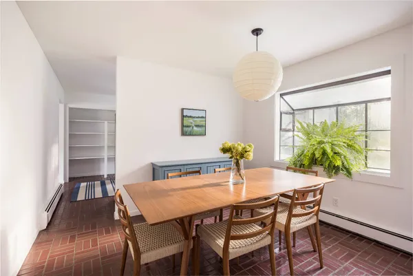 a view of a dining room with furniture and a window