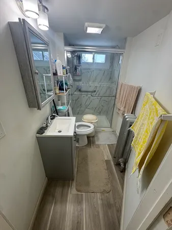 a bathroom with a sink toilet and shower
