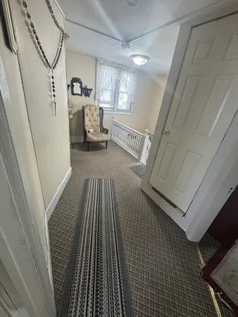 a view of a livingroom with furniture and staircase