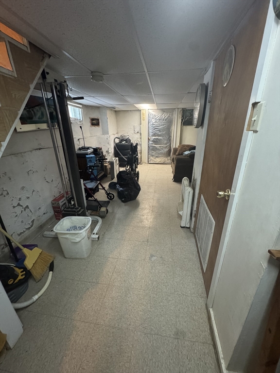 158 Bowles Street Springfield, MA 01109 - Photo 17 of 17 a view of a storage room with water heater and racks