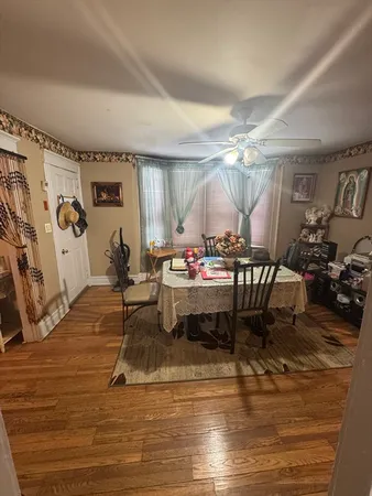 a living room with kitchen island furniture and a wooden floor