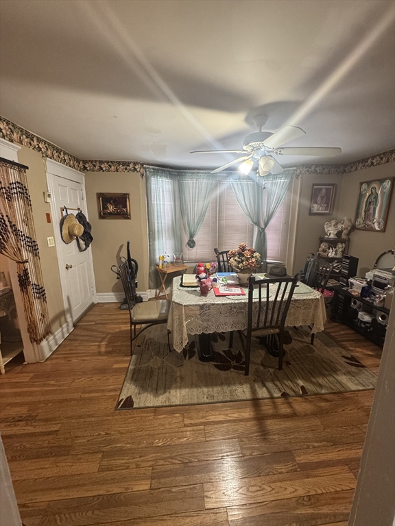158 Bowles Street Springfield, MA 01109 - Photo 5 of 17 a living room with kitchen island furniture and a wooden floor