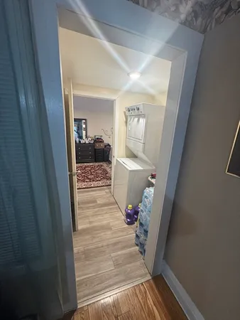 a view of a hallway view with living room and wooden floor