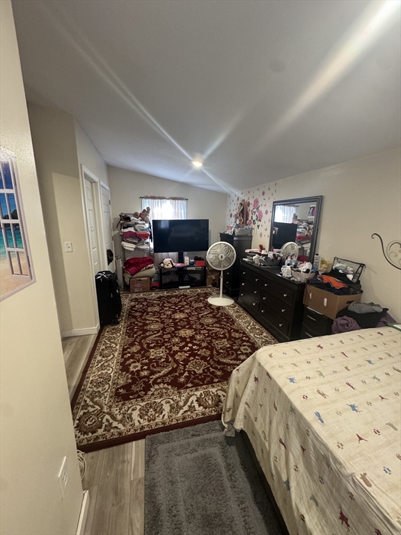 158 Bowles Street Springfield, MA 01109 - Photo 7 of 17 a bed sitting in a bedroom and dresser next to a window