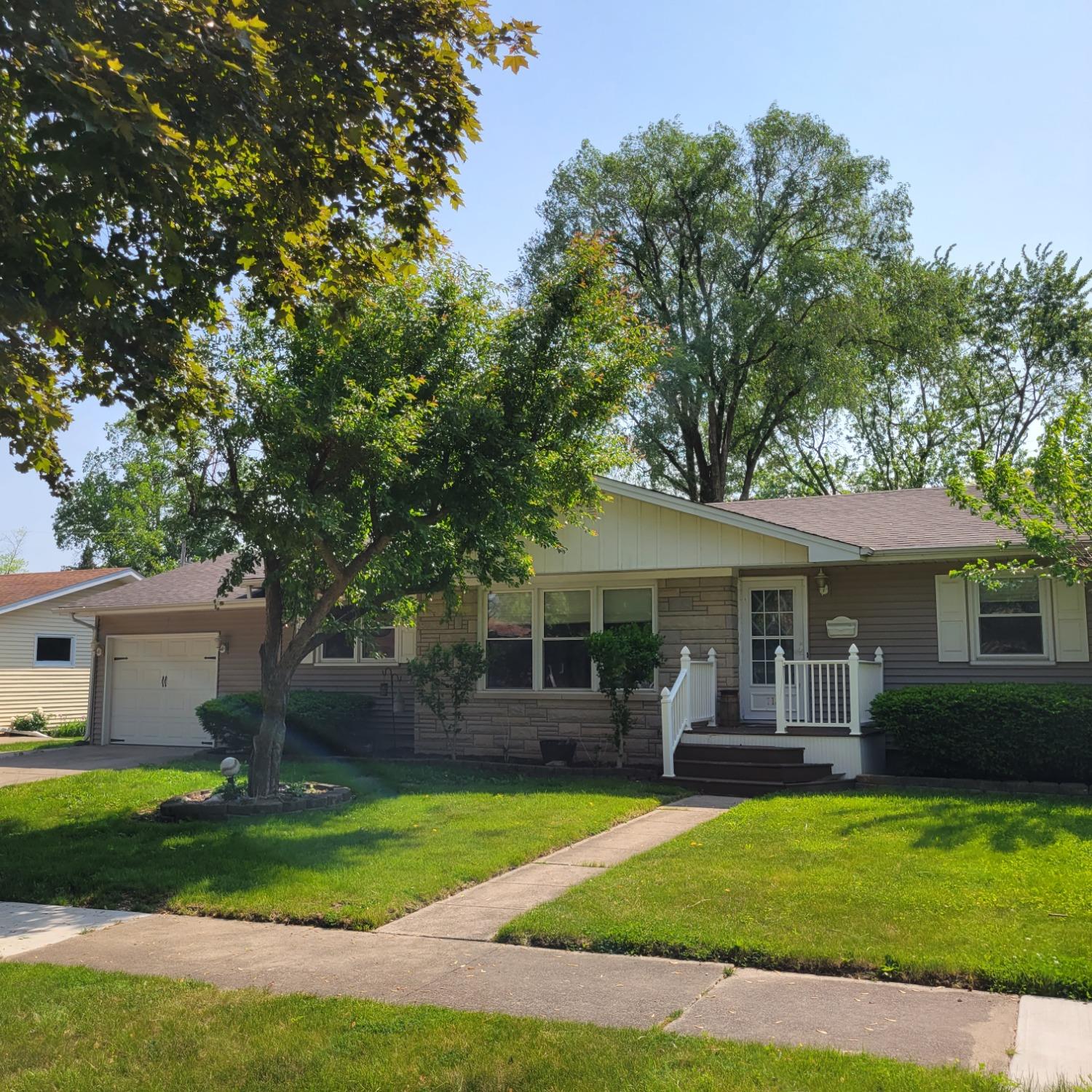 a front view of a house with a garden and porch