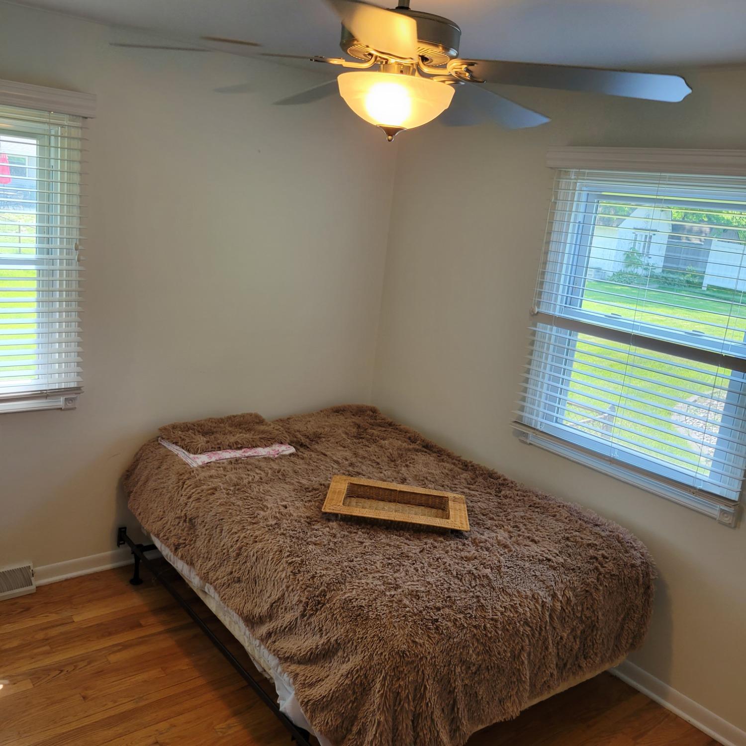 716 South Sherman Street Crown Point, IN 46307 - Photo 12 of 25 a bed sitting in a bedroom next to a window