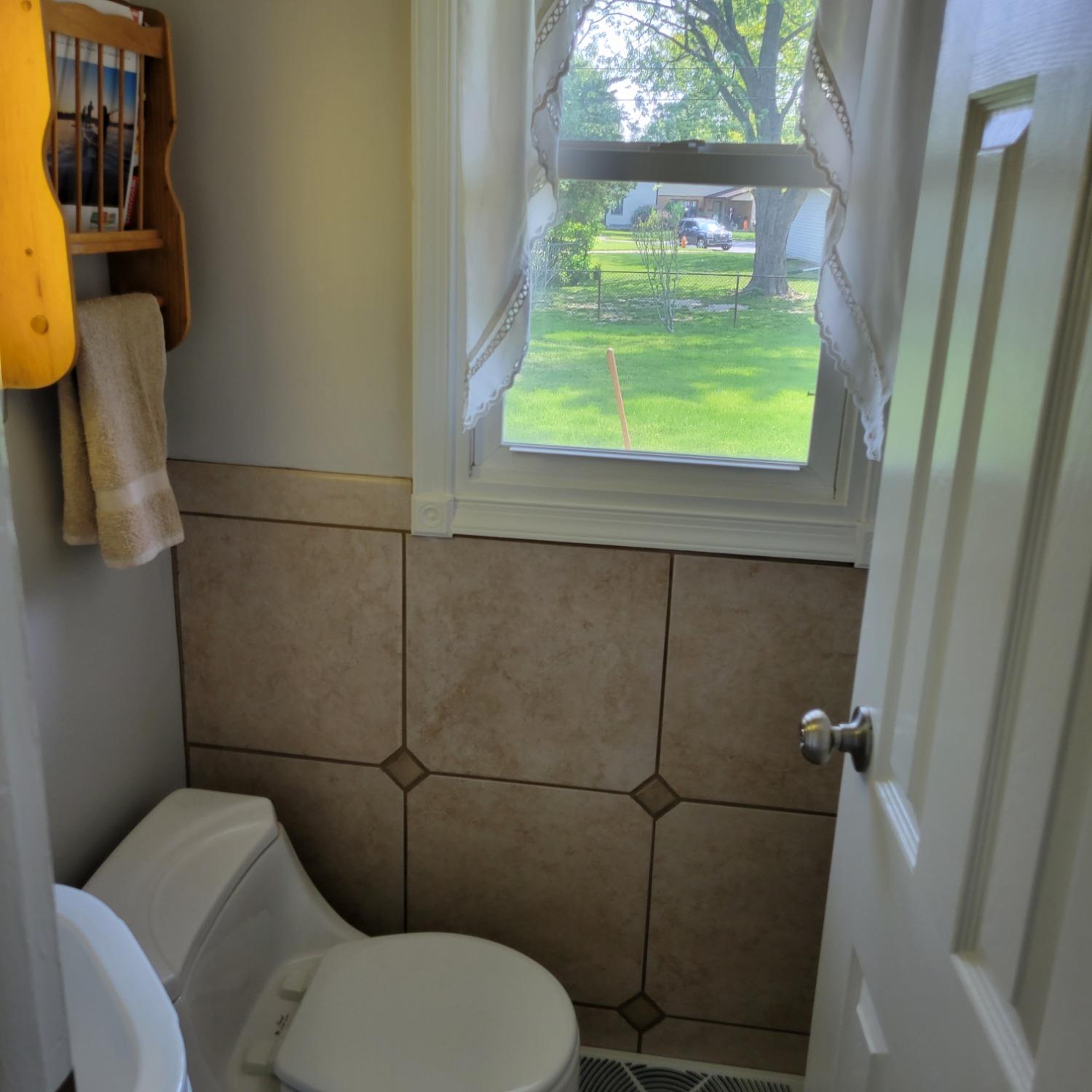 716 South Sherman Street Crown Point, IN 46307 - Photo 13 of 25 a bathroom with a toilet and a window