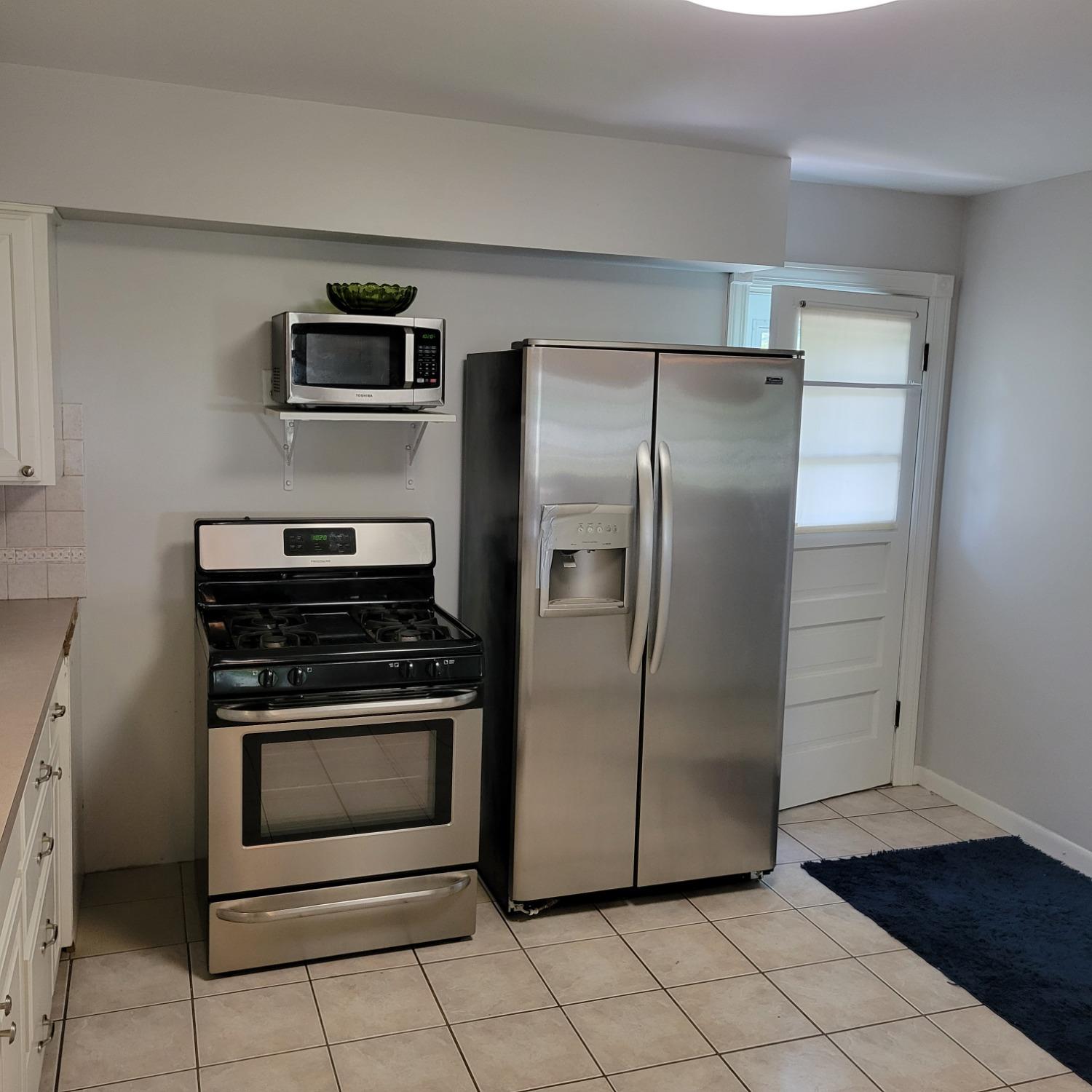 716 South Sherman Street Crown Point, IN 46307 - Photo 7 of 25 a metallic refrigerator freezer and a stove sitting inside of a kitchen
