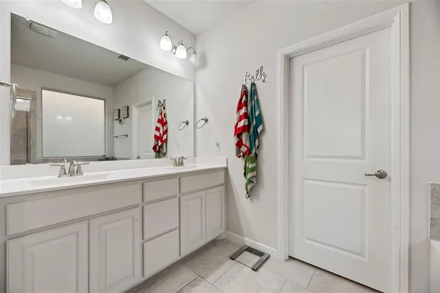 a bathroom with a sink vanity and a mirror