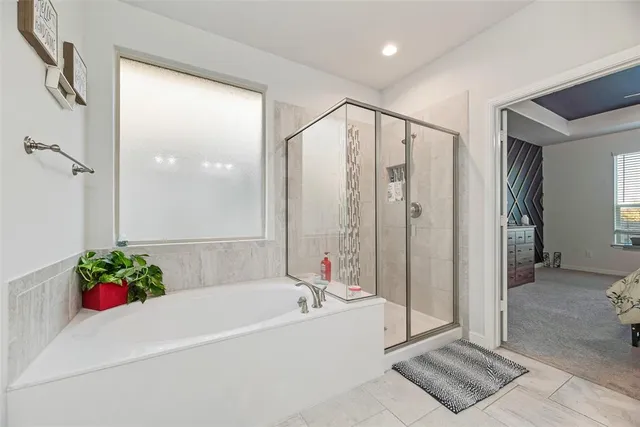 a bathroom with a tub shower and sink
