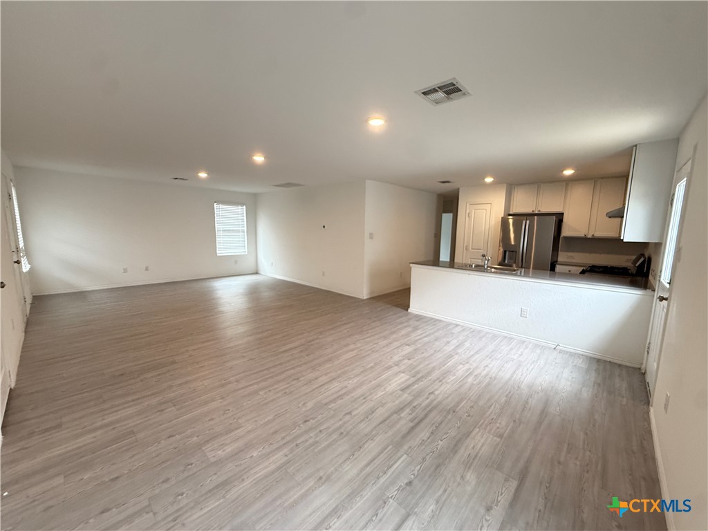 5863 Coahulia Ridge Seguin, TX 78155 - Photo 3 of 15 a view of a kitchen with a sink and a microwave