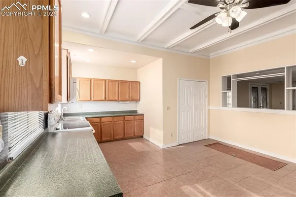a large white kitchen with a large window