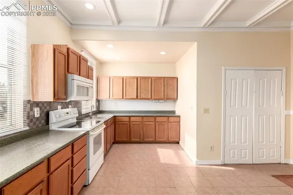 a large kitchen with a sink and cabinets