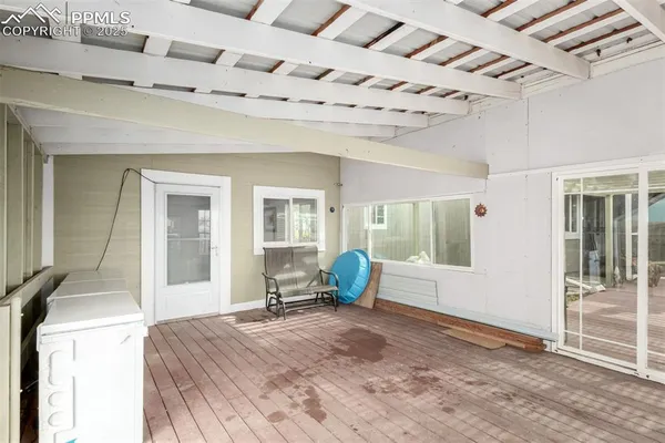 a spacious bedroom with a bed and wooden floor