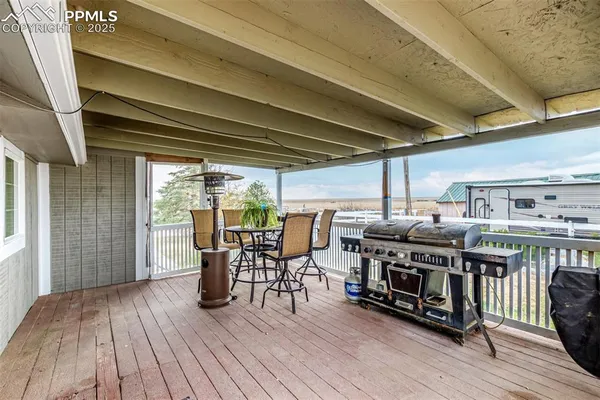 a view of a chairs and table on the deck